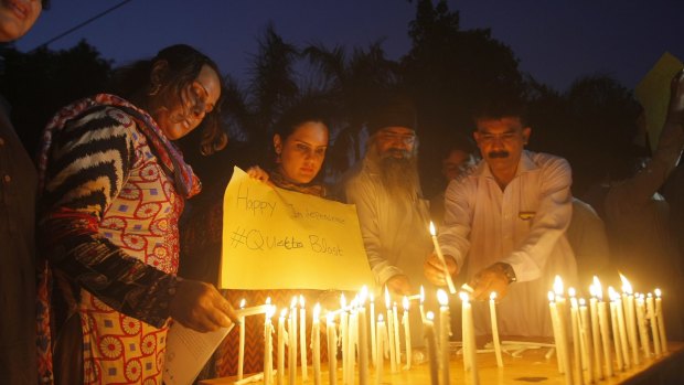 Pakistani civil society activists light candles in Peshawar to pay tribute to the victims of a bombing in Quetta.
