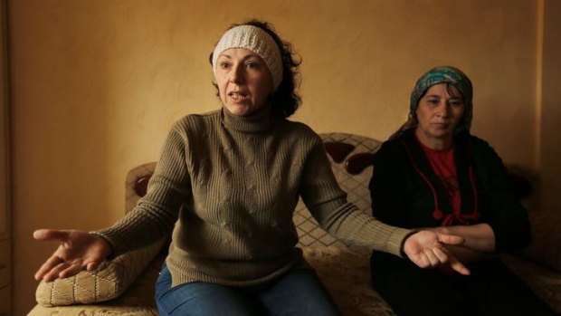 Gulnar Sefedina, left, sits with  Fatima Aliyeda, at a friend's home in Simferepol.