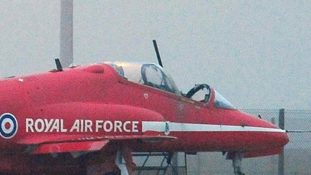 Pilot dead ... a Red Arrows display team Hawk jet with part  of its front canopy missing.