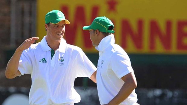 Marchant de Lange and Alviro Petersen celebrate the fall of the wicket of Shane Watson on the opening day of the match between South Africa 'A' and Australia.