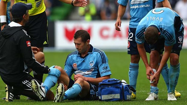 Down and out &#8230; Brett Emerton is treated for an injury during Saturday's match against Melbourne Victory.