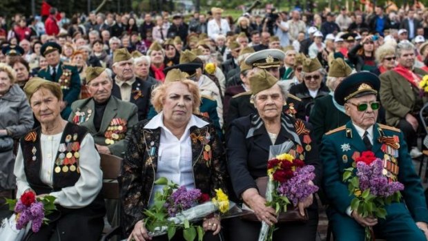 Acts of remembrance: Veterans attend a ceremony to commemorate victims of World War II on the Victory Day holiday on Friday in Donetsk, Ukraine.