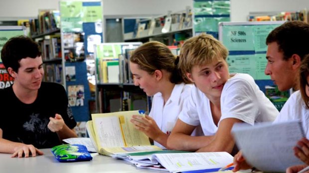 Informal environment &#8230; from left, tutor Neil Barrie works with year 9 student India Bertoli and tutor Harry Nobis helps year 11 student Jack Gencher.