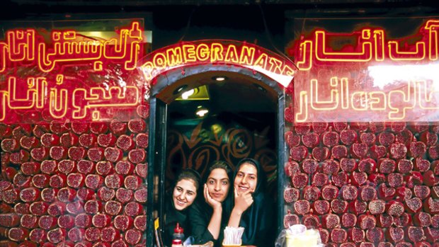 Young Isfahani women working in a pomegranate juice shop.