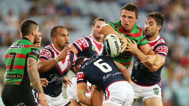 Back on the tools: Sam Burgess offloads to Adam Reynolds.