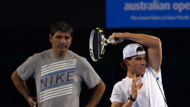 Rafael Nadal practises at Rod Laver Arena under the watchful eye of his uncle and coach, Toni Nadal.