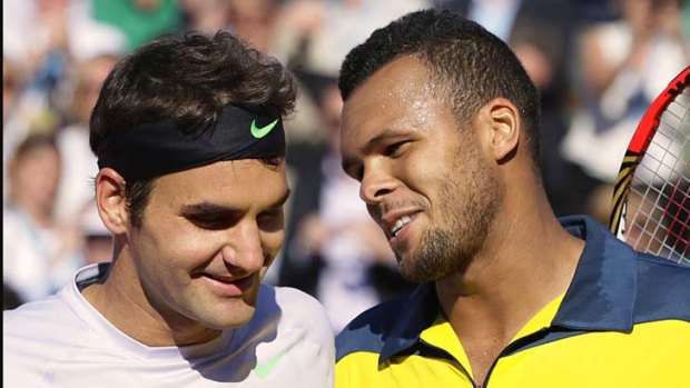 Switzerland's Roger Federer (L) is comforted by France's Jo-Wilfried Tsonga at the end of their quarter final.
