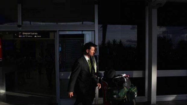 Facing the music . . . Ricky Ponting leaves the arrivals hallon his way to a press conference outside Sydney Airport.