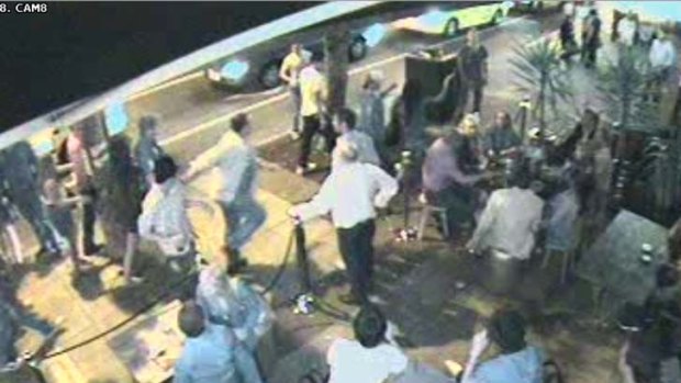 Security footage shows Ron Barassi, in white shirt and jeans, pursuing a man in Fitzroy Street, St Kilda, on New Year's Day 2009.