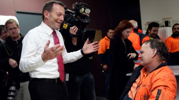 The anti-tax trail ... Tony Abbott visits a factory in Dandenong yesterday.