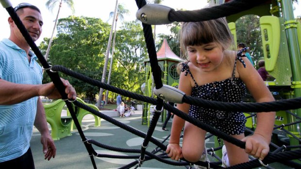 Paige Caruana, 5, enjoys the All-Abilities playground with her dad Ryan Caruana at the City Botanic Gardens in Brisbane.