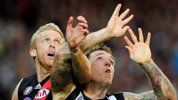 Eyes on the prize: Dustin Fletcher (left) tangles with Anzac Medal winner Dane Swan yesterday.