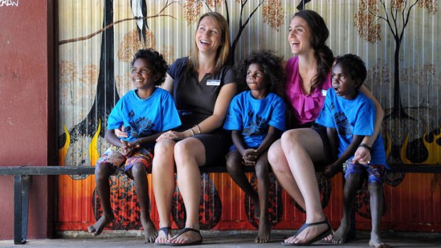 Teachers Nicole Peeler and Naomi Gibb, with students from the Aurukun school, are in no hurry to leave their Cape York jobs.