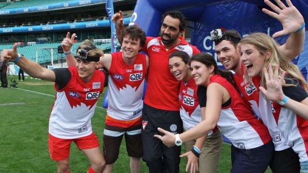 On the job: Adam Goodes with ''Best Job in the World'' contestants at the SCG on Friday.