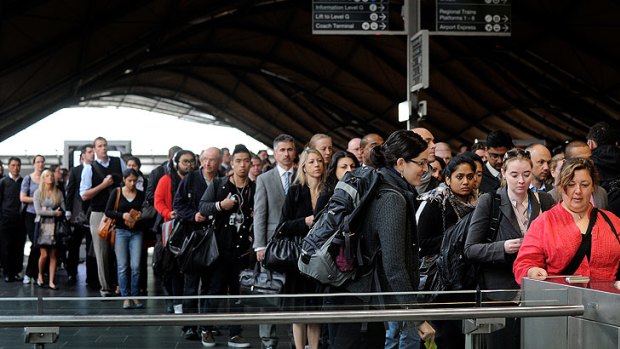 Passengers queue at 'Frankenbarriers' at Southern Cross station.
