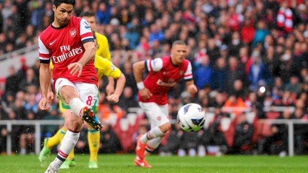 Mikel Arteta of Arsenal scores a controversial penalty.