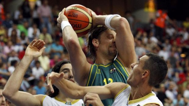 Live action: Aron Baynes grabs a rebound between Argentina players at FIBA, 2010.