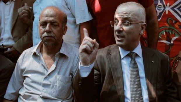 Mohammed's father, Hussein Abu Khedair, left, with Palestinian Prime Minister Rami Hamdallah.