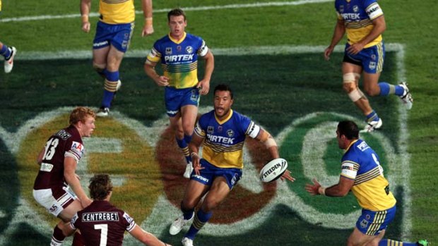 Fun of the flair ... Parramatta's Joseph Paulo floats back a ball during last night's victory over Manly.