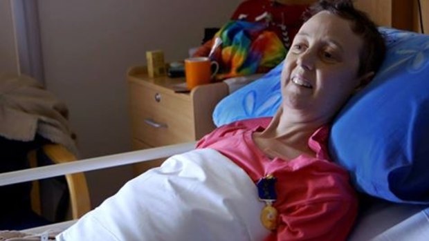Connie proudly wears her Medal of the Order of Australia in her hospice bed in Canberra.