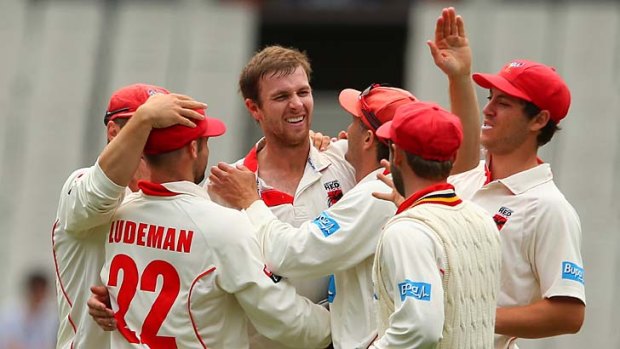 Gary Putland of the Redbacks is congratulated by team mates after snaring the wicket of Louis Cameron.