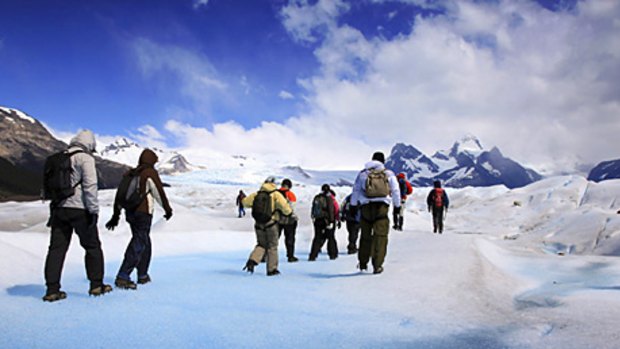 Chills to the gills ... tourists walk on Perito Moreno glacier to one of several vantage points to watch hunks of ice breaking into Lake Argentine.