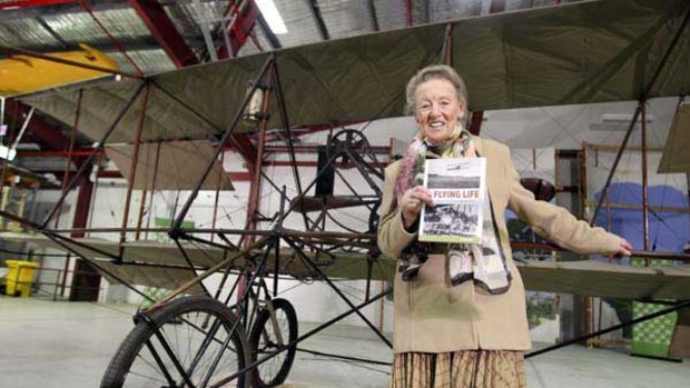 Gwynne Duigan with John Duigan's original biplane at Museum Victoria's warehouse.