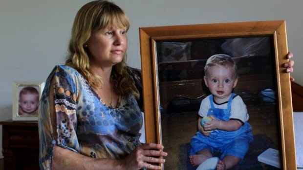 Sorely missed: Sue Steele holds a portrait of her son, Scott, who was killed in a car accident in Dee Why.