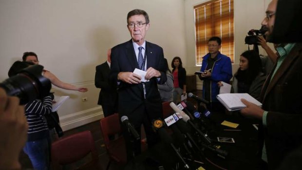 'Very inexact science': Angus Houston leaves Tuesday's news conference.