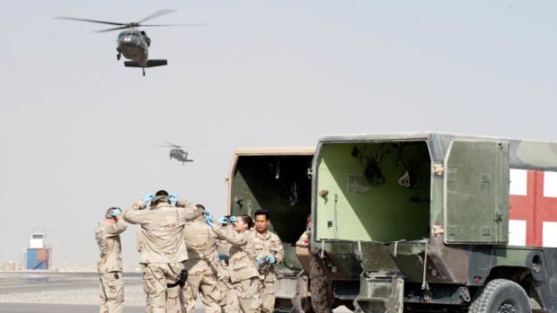 Evacuation ... medics prepare to receive patients from coalition medical helicopters at Kandahar.