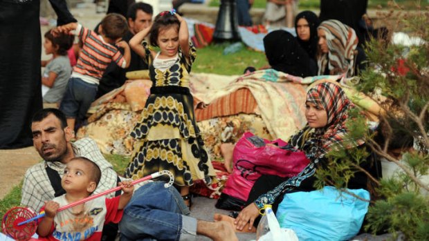 Choosing exile ... Syrian nationals fleeing the 16-month conflict in their home country gather in a garden in Port Said Square in Algiers.