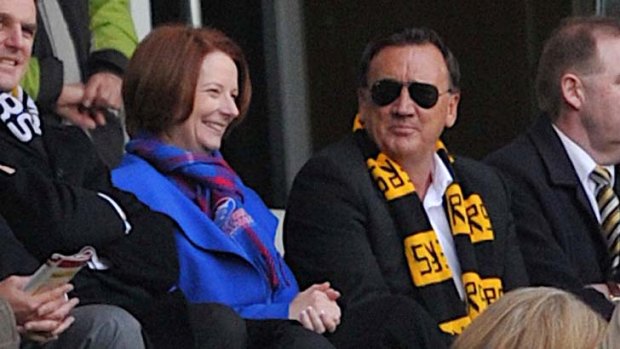 Fans ... Julia Gillard, with partner Tim Mathieson, at an AFL game earlier this year. She is yet to declare tickets to the grand final.