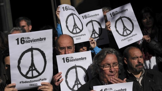 Members of Spanish trade unions hold up banners that read ''November 16. We Are All Paris'' as they stand during a minute of silence for victims of the Paris attack.