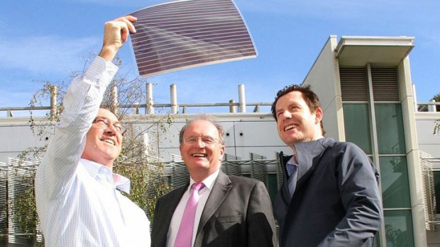 Dr David Jones, Professor Andrew Holmes and Dr Scott Watkins with a new plastic solar cell. Photo: CSIRO