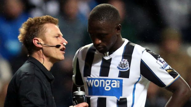 On the nose: Referee Mike Jones (left) talks to Moussa Sissoko.