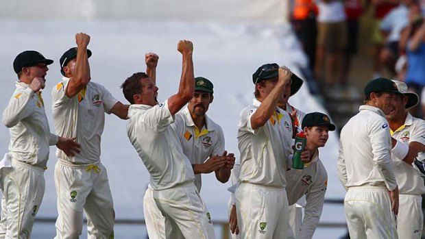 Peter Siddle celebrates with teammates after taking the wicket of Ian Bell.