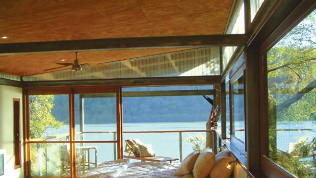 Among the gum trees. . . the bedroom opens out to a deck at the Tree House.