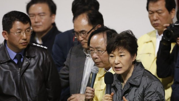 Angry reception ... South Korean President Park Geun-hye speaks to family members of missing passengers who were on South Korean ferry "Sewol", which sank at the sea off Jindo, during her visit to Danwon High School gym where family members gathered.
