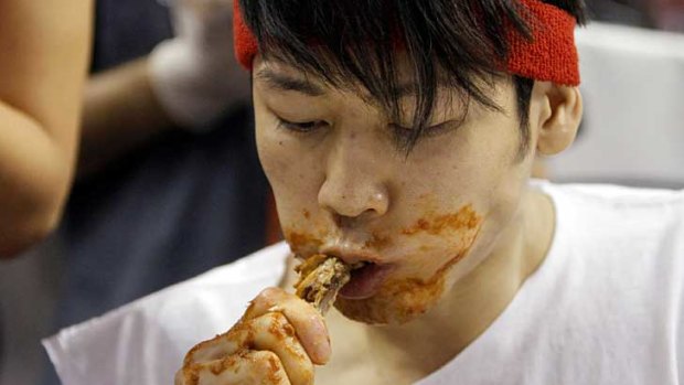 Takeru Kobayashi devours a chicken wing at Wing Bowl XX.