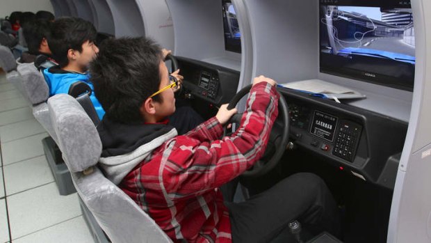 Streets ahead: Students try out driving simulators.