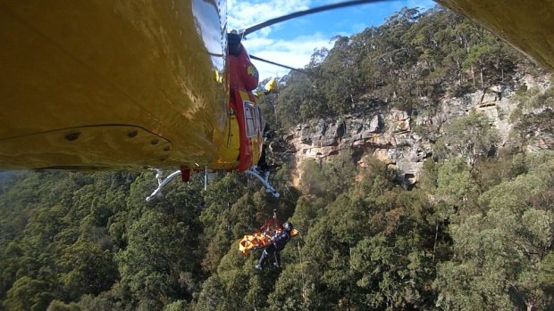 Paramedics use a helicopter to rescue a 17-year-old who fell 80 metres at the Watagan Mountains.