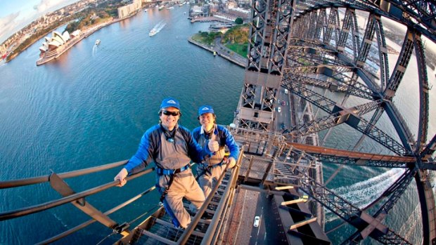 Two Chinese ‘incentive tourists’ climb the Harbour Bridge.