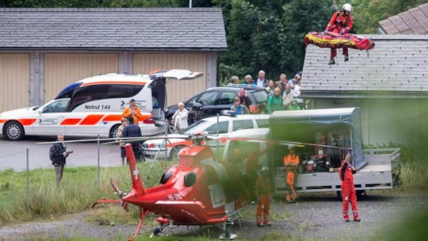 Rescue workers airlift a person injured in a train crash near Tiefencastel, Switzerland.