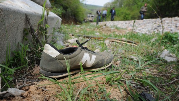 A shoe lays by the rail tracks north of the central Macedonian town of Veles near the site where 14 migrants were killed by a train while walking along the tracks.