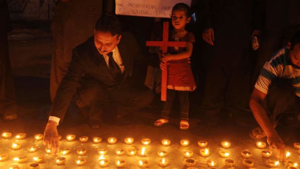 Tribute: Candles are lit for the victims of a church suicide bomb attack, which led to the cancellation of peace talks with the Taliban.