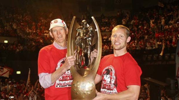 Homecoming bash ... Dragons coach Wayne Bennett and captain Ben Hornby with the NRL premiership trophy in Wollongong yesterday.