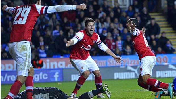 Arsenal's English striker Theo Walcott (R) celebrates scoring Arsenal's sixth goal.