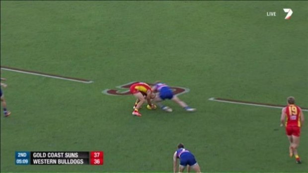 Bulldog Adam Cooney makes forceful contact with Gary Ablett.