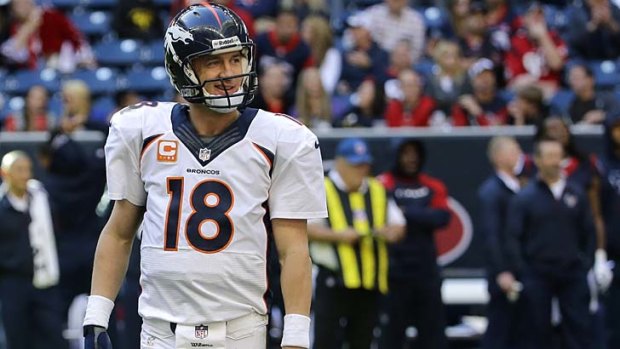 Record breaker: Peyton Manning smiles after throwing his 51st touchdown pass for the season, breaking the previous NFL one-season mark held by Tom Brady.