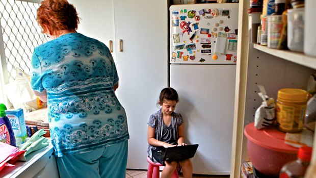 Taking care ... Niloofar Veiszadeh, 8, uses her laptop in the kitchen. Australian children are among the most prolific online users.